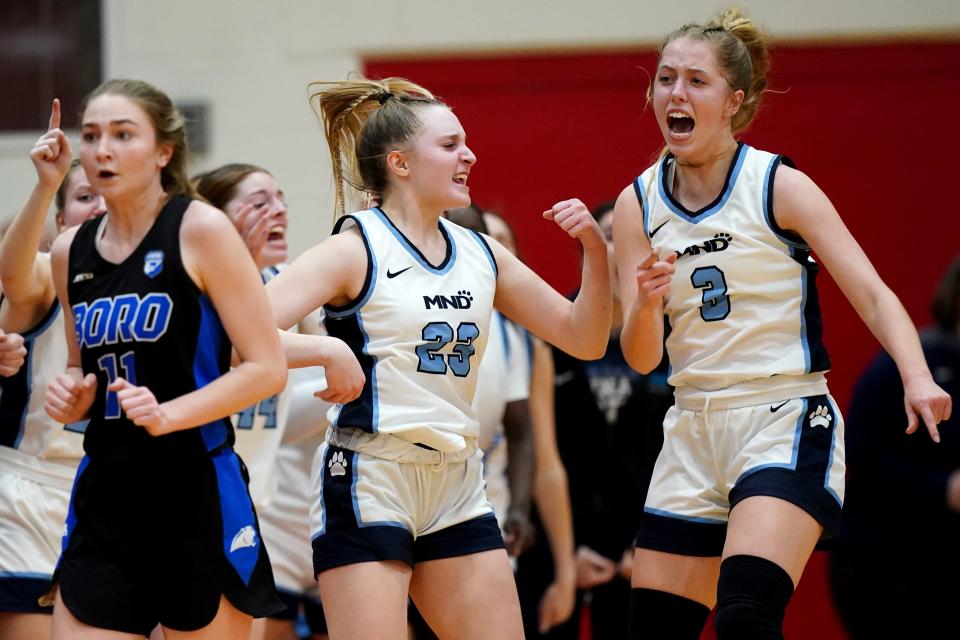 Mount Notre Dame Cougars shooting guard Zelie Hoover (23) and Mount Notre Dame Cougars shooting guard Grace Pitzer (3) react to a turnover of Springboro Panthers guard Morgan Meek (11 )in the first half of an OHSAA Division I girls regional final game, Saturday, March 9, 2024, at Lakota West High School in West Chester Township, Ohio.