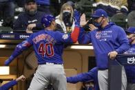 Chicago Cubs' Willson Contreras celebrates with manager David Ross after hitting a two-run home run during the eighth inning of a baseball game against the Milwaukee Brewers Tuesday, April 13, 2021, in Milwaukee. (AP Photo/Morry Gash)