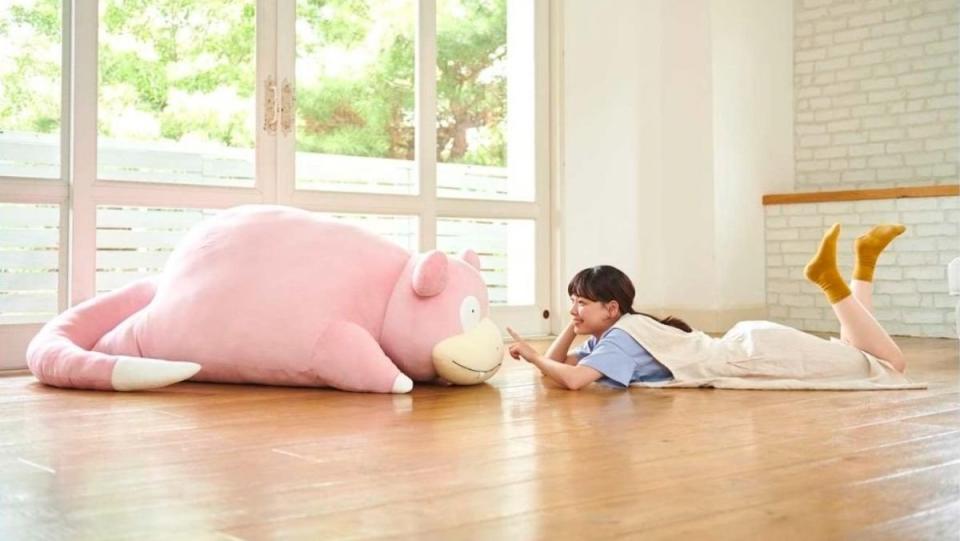 pokemon giant slowpoke plush on the floor with person