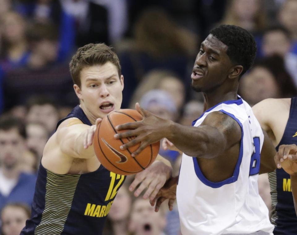 Marquette's Matt Heldt (12) and Creighton's Cole Huff, right, reach for a loose ball during the first half of an NCAA college basketball game in Omaha, Neb., Saturday, Jan. 21, 2017. (AP Photo/Nati Harnik)