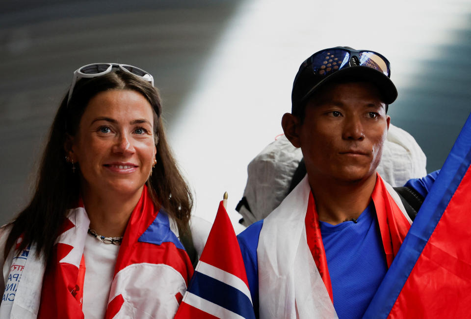 Norwegian mountaineer Kristin Harila, 37, along with Nepali mountaineer Tenjen (Lama) Sherpa, 35, pose for a picture upon their arrival at the airport after becoming the world's fastest climbers to scale all peaks above 8,000 meters in the shortest time, in Kathmandu, Nepal, August 5, 2023. REUTERS/Navesh Chitrakar