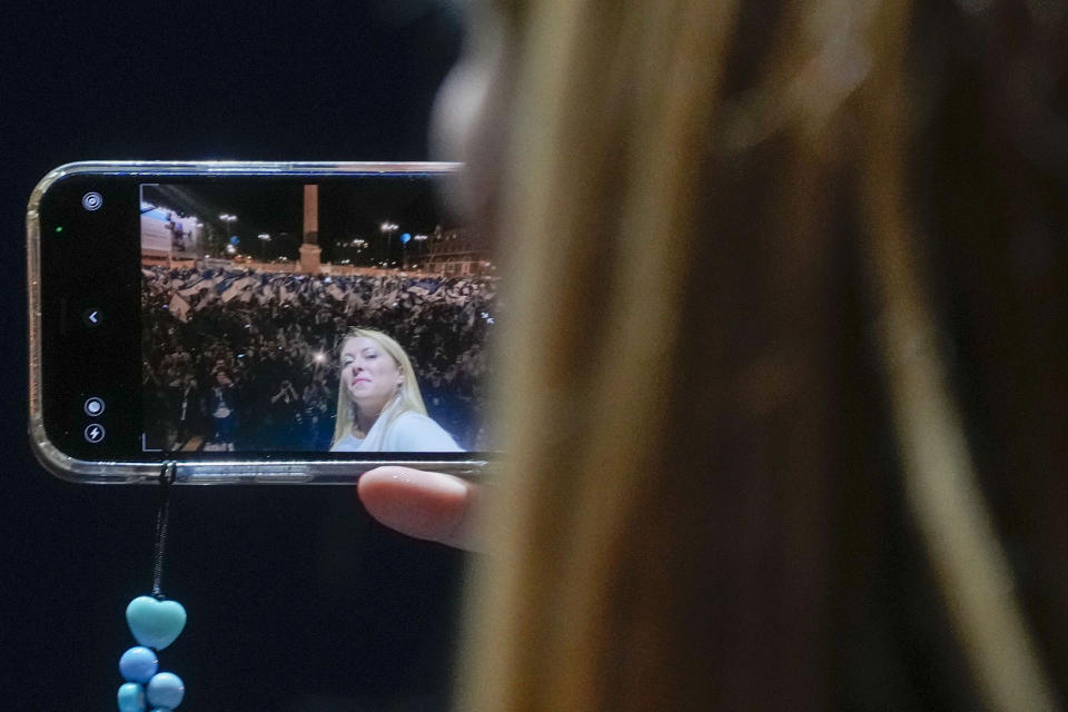 Brothers of Italy's Giorgia Meloni snaps a selfie movie during the center-right coalition closing rally in Rome Thursday, Sep. 22, 2022. Italians vote on Sunday for a new Parliament, and they could elect their first far-right premier of the post-war era. If opinion polls hold, Giorgia Meloni could be that premier, as well as become the first woman to lead an Italian government. (AP Photo/Gregorio Borgia)