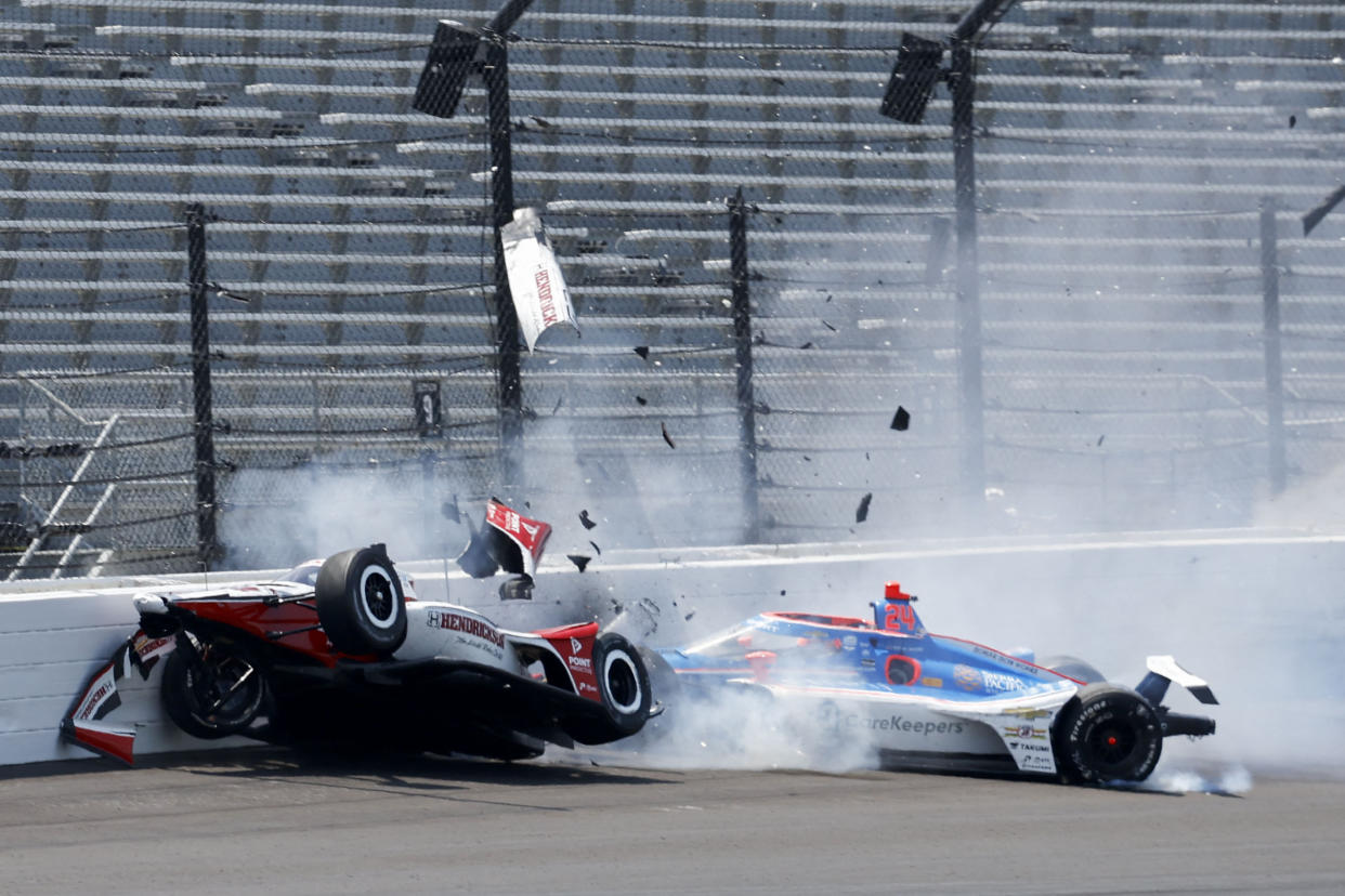 May 22, 2023; Speedway, Indiana, USA;Rahal Letterman Lanigan Racing driver Katherine Legge (44) and Dreyer & Reinbold Racing driver Stefan Wilson (24) crash in the first turn Monday, May 22, 2023, during practice ahead of the 107th running of the Indy 500 at Indianapolis Motor Speedway. Mandatory Credit: John Chilton-USA TODAY Sports