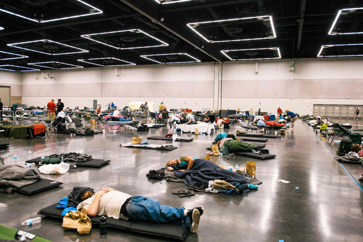 People rest at the Oregon Convention Center cooling station in Portland, Ore., on June 28, 2021