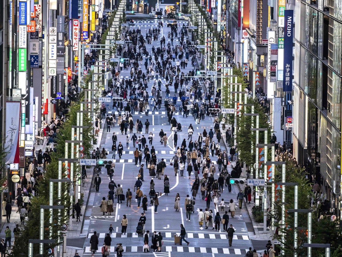 File. People walking on a street in Tokyo’s Ginza area at dusk  (AFP via Getty Images)