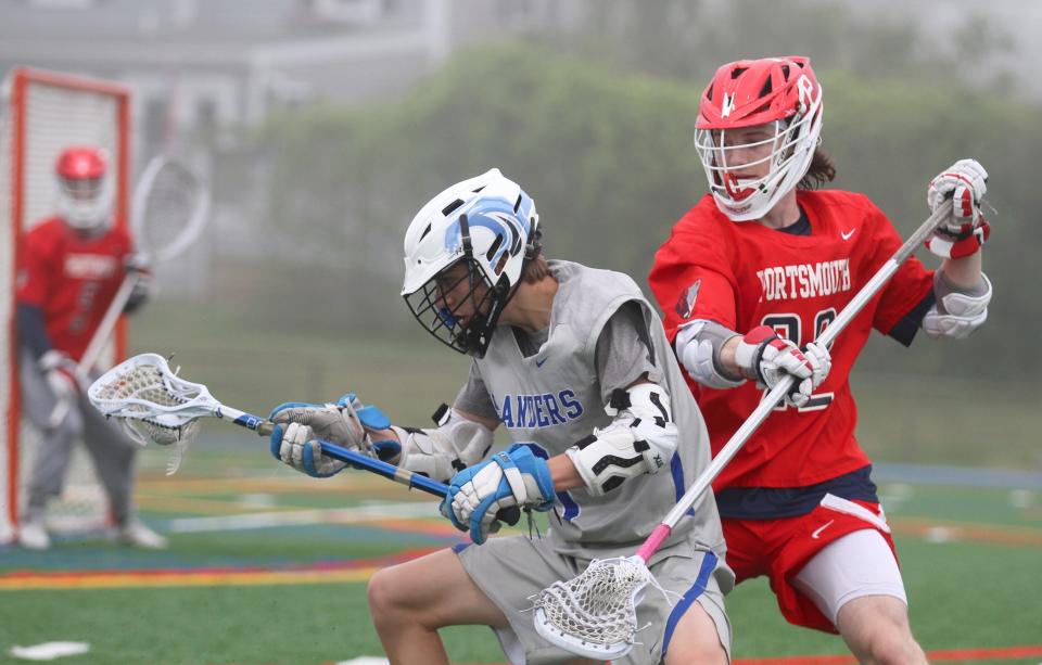 Middletown's Matt O'Hagan, left, is tightly defended by Portsmouth's Joe Rocco during a game on May 13 in Middletown.