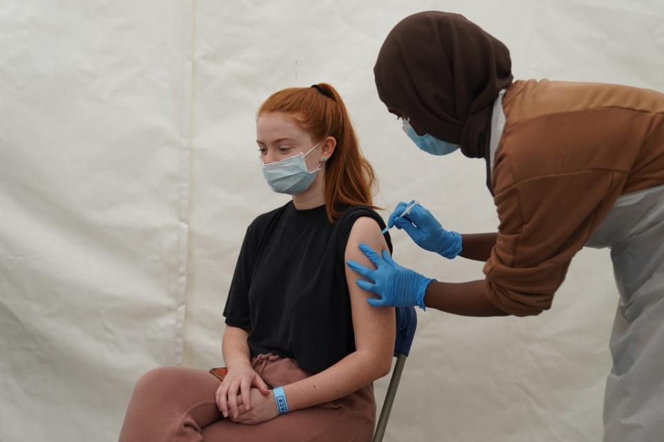 A girl receives a Covid-19 jab at a pop-up vaccination centre during a four-day vaccine festival in east London (Kirsty O’Connor/PA) (PA Wire)