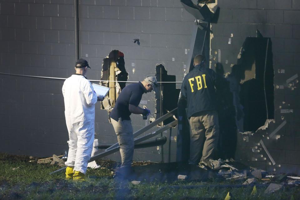 <p>FBI agents investigate near the damaged rear wall of the Pulse Nightclub where Omar Mateen allegedly killed at least 50 people on June 12, 2016 in Orlando, Florida. (Joe Raedle/Getty Images) </p>