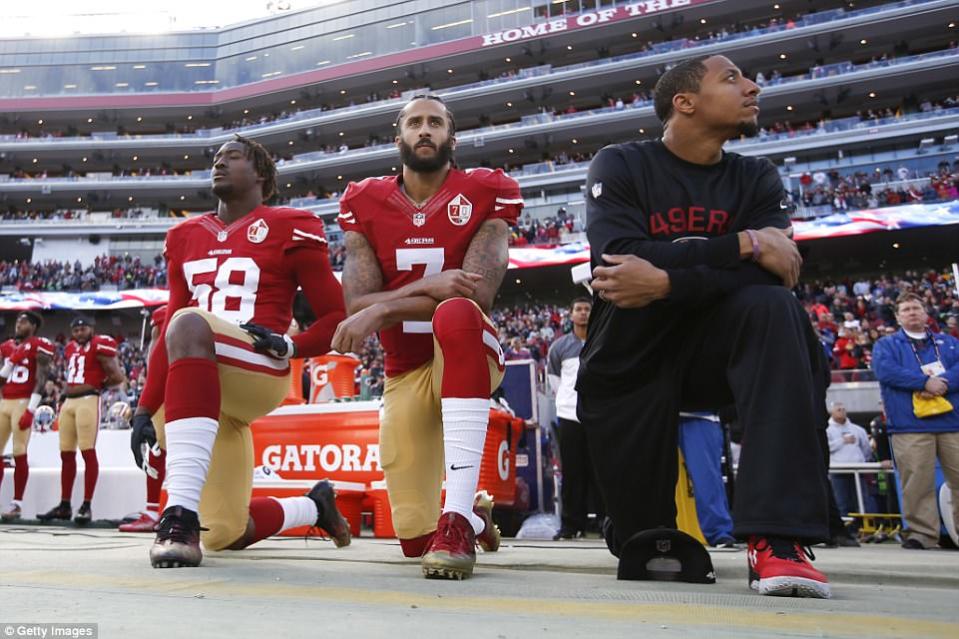 Colin Kaepernick (centre) was the first to drop a knee as a protest against police brutality. (Getty)