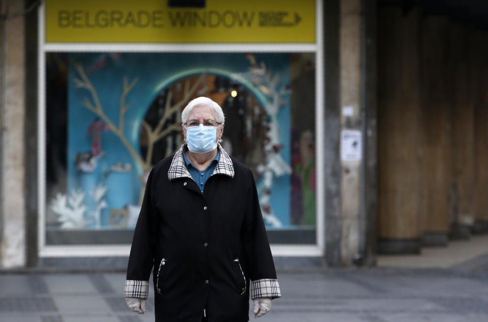 An elderly woman wearing a mask against the spread of the new coronavirus walks during a curfew in downtown Belgrade, Serbia, Tuesday, April 21, 2020. Serbia's elderly on Tuesday ventured outside their homes for the first time in more than a month as the authorities eased some of the strict measures that have been in place against the new coronavirus. Serbia has introduced some of the toughest rules in Europe as part of efforts to curb the spread of the virus. (AP Photo/Darko Vojinovic)