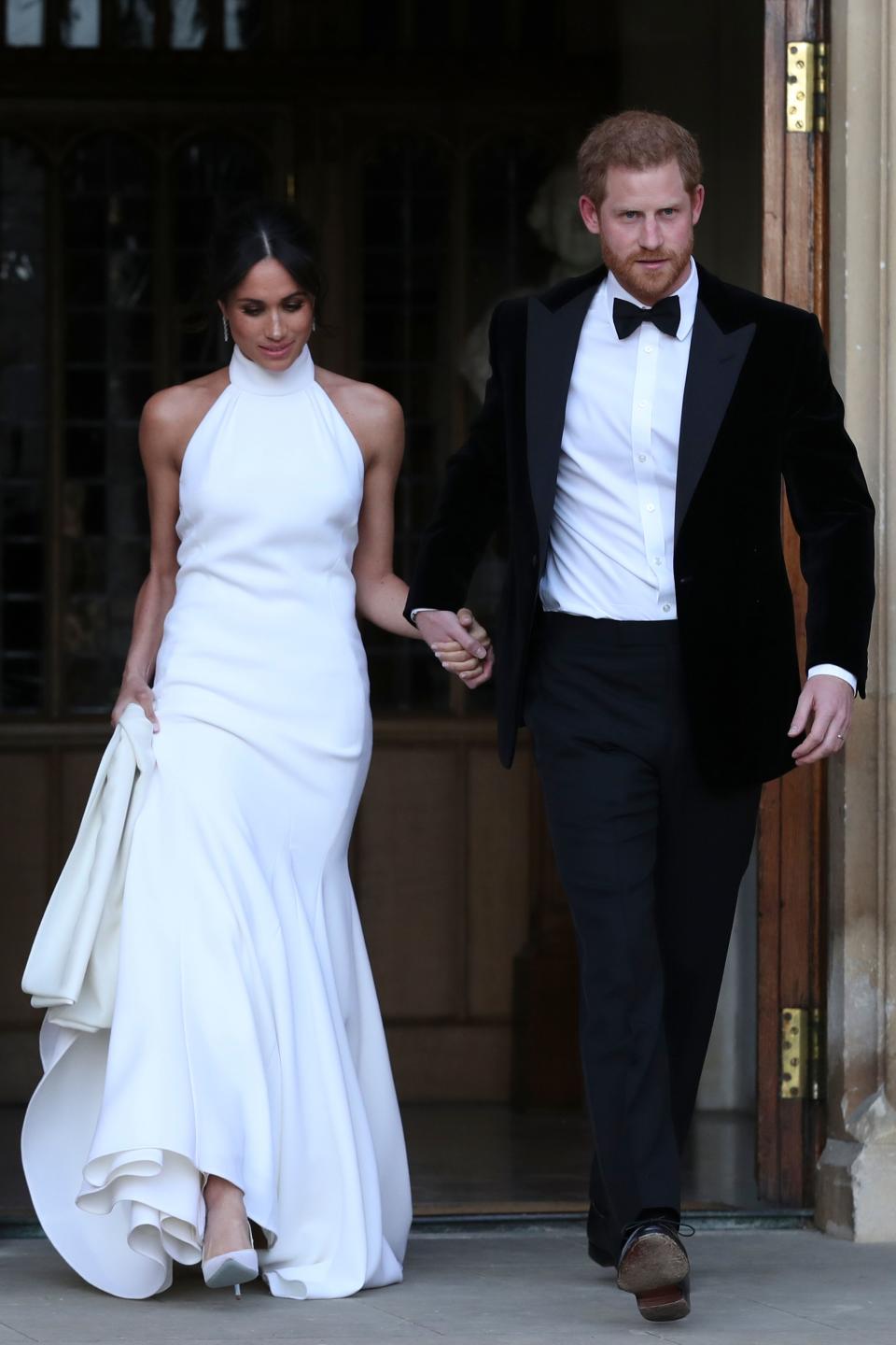 Markle traded her boatneck gown for a Stella McCartney dress for the newlyweds' reception at Frogmore House. The piece was later released for people to buy. (Photo: Getty Images)