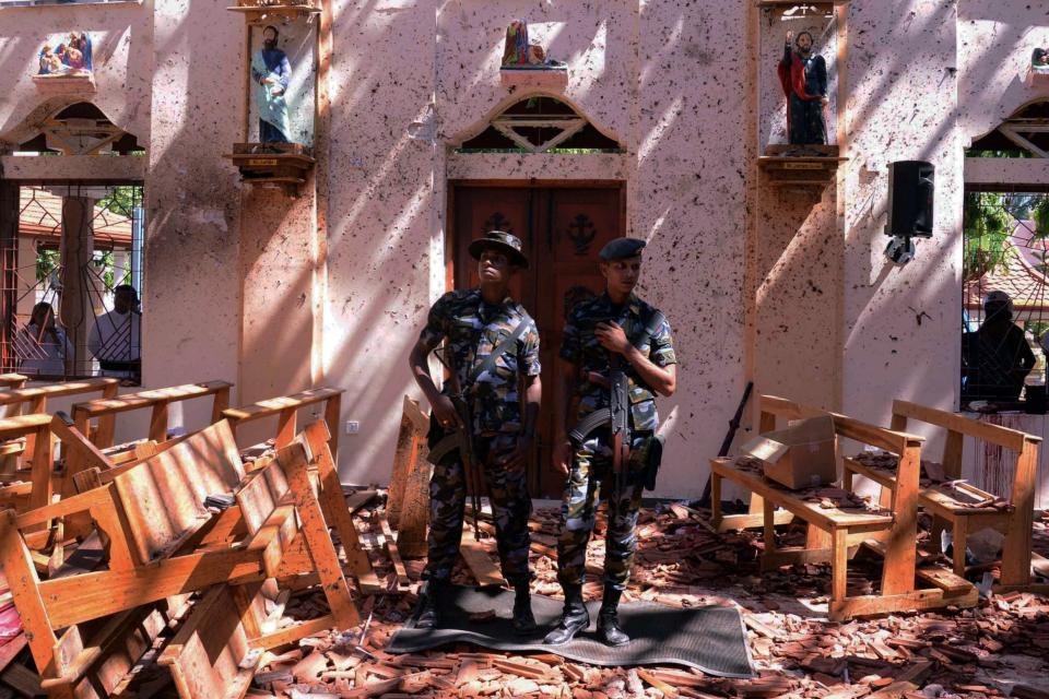 Sri Lankan military stand guard inside a church after an explosion in Negombo, Sri Lanka (REUTERS)