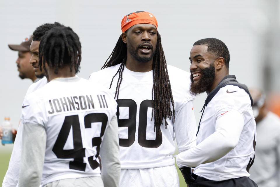 Cleveland Browns' Jadeveon Clowney (90) talks with John Johnson III (43) and Anthony Walker Jr. during an NFL football practice at the team's training facility Wednesday, May 25, 2022, in Berea, Ohio. (AP Photo/Ron Schwane)