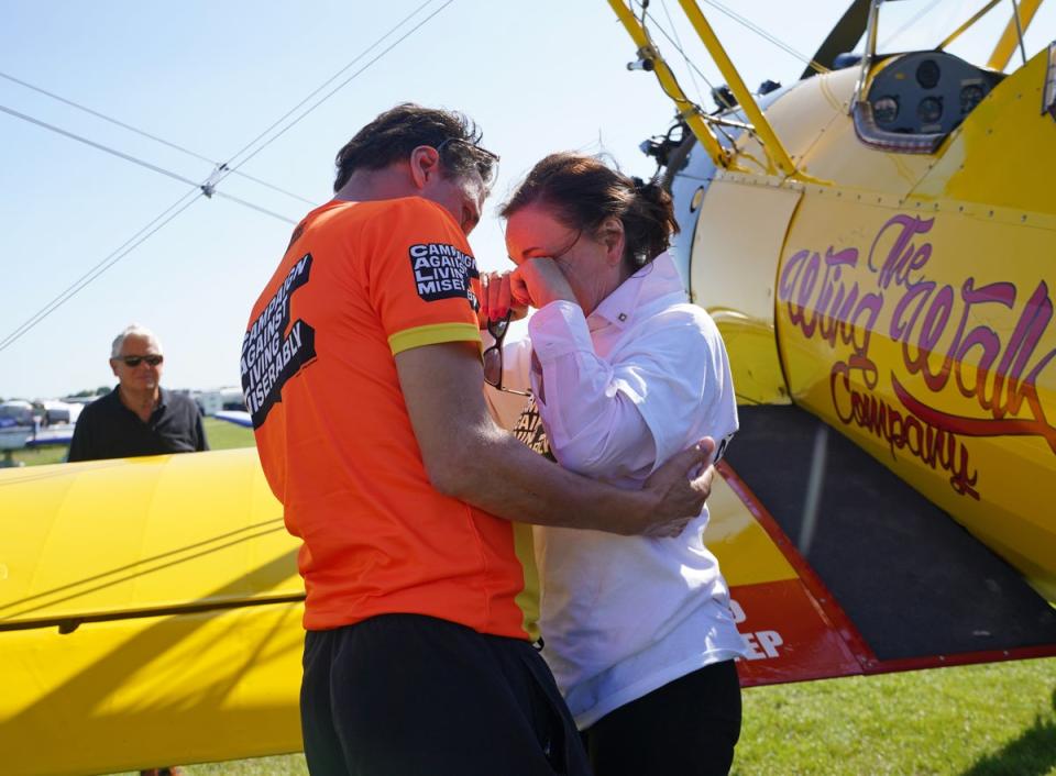 Shirley Ballas is embraced by Daniel Taylor after completing her wing walk  for the Campaign Against Living Miserably (CALM) (PA)