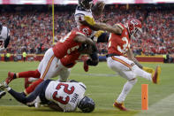 Houston Texans quarterback Deshaun Watson (4) scores a touchdown against Kansas City Chiefs linebacker Anthony Hitchens (53) and safety Tyrann Mathieu (32) during the second half of an NFL divisional playoff football game, in Kansas City, Mo., Sunday, Jan. 12, 2020. (AP Photo/Charlie Riedel)