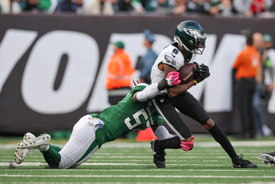 Oct 15, 2023; East Rutherford, New Jersey, USA; Philadelphia Eagles wide receiver <a class="link " href="https://sports.yahoo.com/nfl/players/33398" data-i13n="sec:content-canvas;subsec:anchor_text;elm:context_link" data-ylk="slk:DeVonta Smith;sec:content-canvas;subsec:anchor_text;elm:context_link;itc:0">DeVonta Smith</a> (6) is tackled by New York Jets linebacker C.J. Mosley (57) during the first half at MetLife Stadium. Mandatory Credit: Vincent Carchietta-USA TODAY Sports