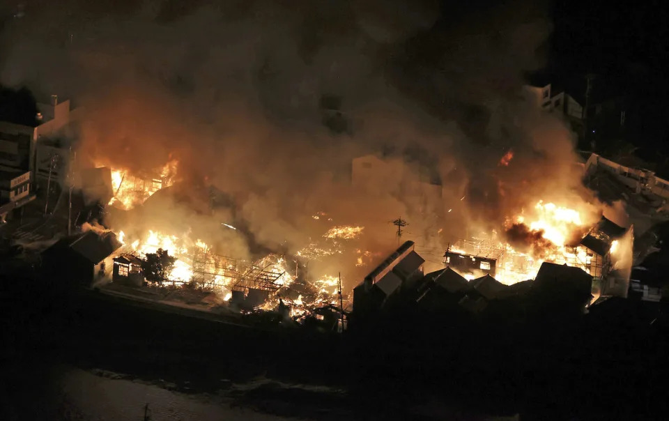 An aerial photo shows a fire due to a massive earthquake in Wajima City, Ishikawa Prefecture on Jan. 1, 2024.  (Takehito Kobayashi / The Yomiuri Shimbun via AP)