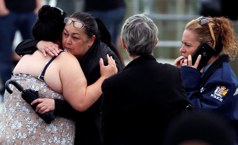 Relatives hug as they wait for rescue mission, following the White Island volcano eruption in Whakatane