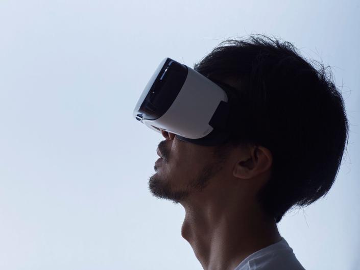 A stock image of a man using a virtual reality headset
