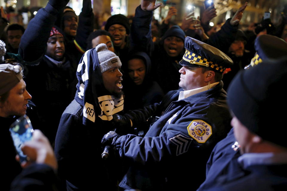 Demonstrators confront cops during a protest over the fatal shooting of Laquan McDonald in Chicago. Emanuel has struggled to explain the concealment of a video of the shooting. (Photo: Andrew Nelles / Reuters)