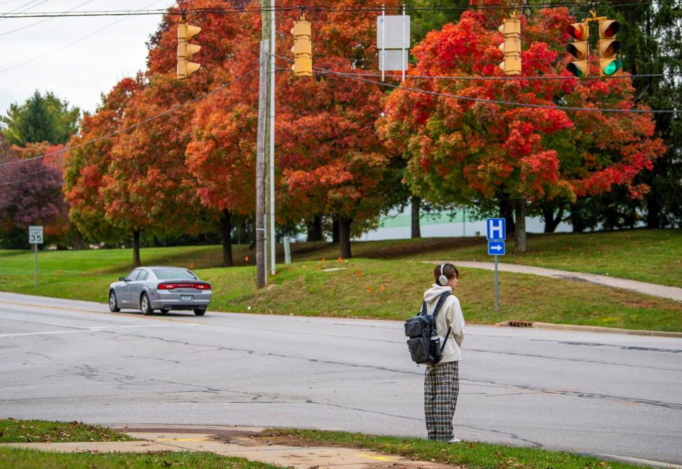 A man waits to cross at the corner of Pete Ellis Drive and 10th Street on Tuesday, Oct. 17, 2023.