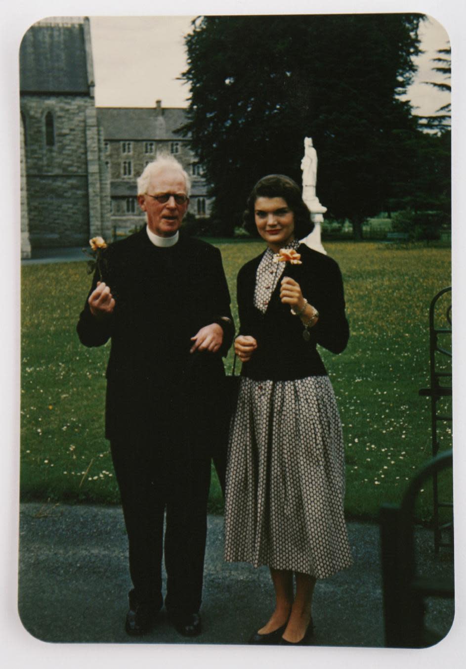 In this image made available by Sheppard's Irish Auction House made available on Wednesday May 14, 2014 shows Rev. Joseph Leonard with Jacqueline Kennedy at All Hallows College in Dublin Ireland in 1950. Letters written by Jacqueline Kennedy to an Irish priest have revealed new details about her closely guarded private thoughts. The letters are set to be auctioned next month and could fetch up to $1.6 million. The more than 30 letters were written to the Rev. Joseph Leonard. They were recently discovered in a drawer at All Hallows College. In one, she questioned her faith after the assassination of President John F. Kennedy. "I am so bitter against God," she wrote a few months after the assassination of her husband. (AP Photo/Sheppard's Irish Auction House) NO ARCHIVE ONE TIME USE ONLY ONLY TO BE USE IN CONNECTION WITH STORY RELATED TO THE AUCTION