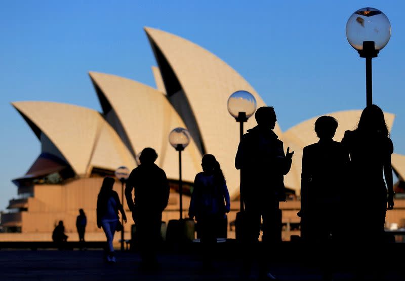 FILE PHOTO: People are silhouetted against the Sydney Opera House at sunset in Australia