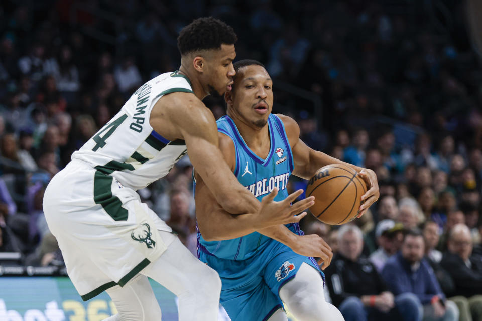 Charlotte Hornets forward Grant Williams, right, is fouled as he drives against Milwaukee Bucks forward Giannis Antetokounmpo, left, during the first half of an NBA basketball game in Charlotte, N.C., Thursday, Feb. 29, 2024. (AP Photo/Nell Redmond)