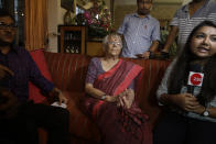 Nirmala Banerjee, mother of Abhijit Banerjee, center, interacts with media after Nobel Prize in economics was announced at her home in Kolkata, India, Monday, Oct. 14, 2019. The 2019 Nobel Prize in economics was awarded Monday to Abhijit Banerjee, Esther Duflo and Michael Kremer for pioneering new ways to alleviate global poverty. (AP Photo/Bikas Das)