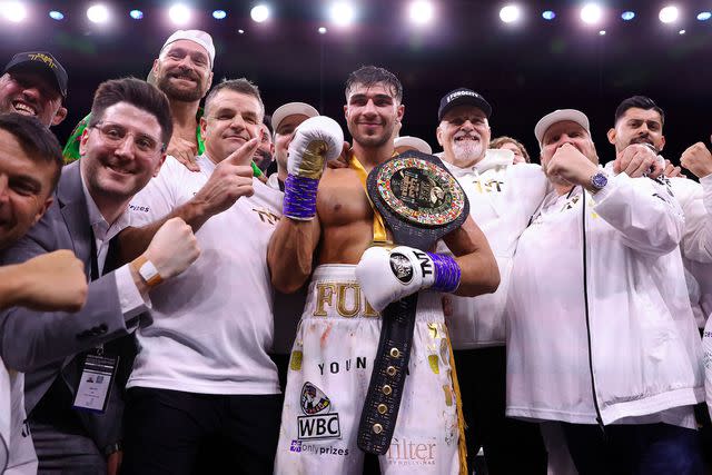 <p>Francois Nel/Getty</p> Tommy Fury with his coaching team, brother boxer Tyson Fury and father John Fury after defeating Jake Paul during the Cruiserweight Title fight in 2023