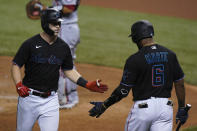 Miami Marlins' Corey Dickerson, left, is congratulated by Starling Marte after hitting a home run during the first inning of the second game of a baseball doubleheader against the Washington Nationals, Friday, Sept. 18, 2020, in Miami. (AP Photo/Wilfredo Lee)