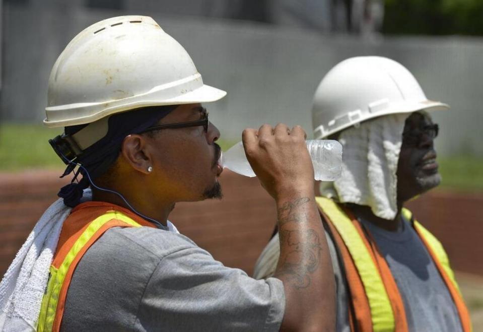 Outdoor workers could face threats from the heat later this week, over the weekend and potentially into early next week. This file photo shows Charlotte-Mecklenburg Utility Department workers replacing water and sewer lines on a hot day.