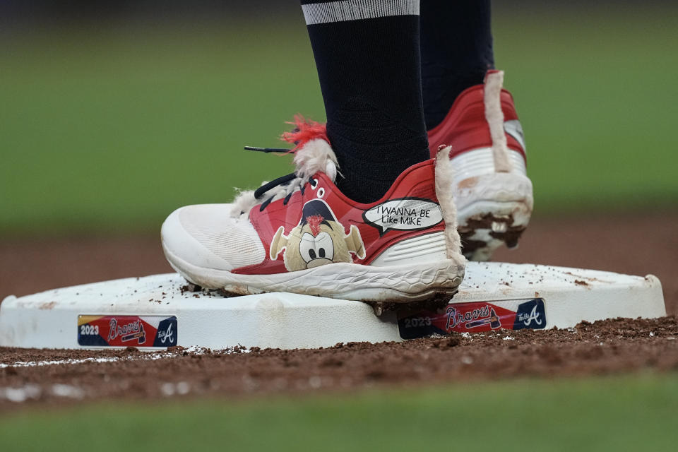 A likeness of Atlanta Braves mascot "Blooper" adorns Michael Harris II's shoe as he stands on third base during the fourth inning of the team's baseball game against the Chicago White Sox on Friday, July 14, 2023, in Atlanta. (AP Photo/John Bazemore)