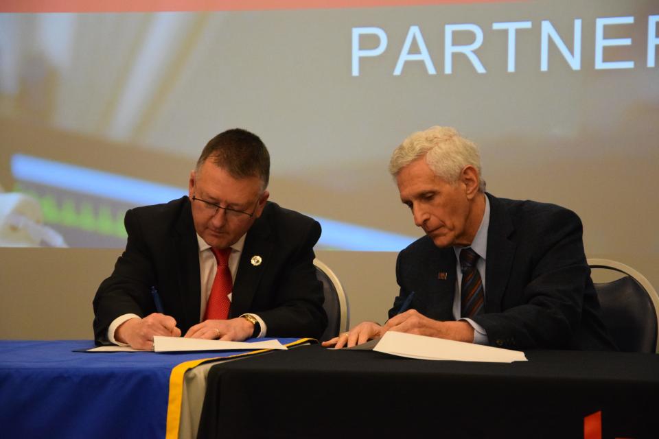 NCMC President David Roland Finley (left) and Davenport University President Richard Pappas sign the formal agreement allowing NCMC nursing graduates to transfer to Davenport without losing any credits.