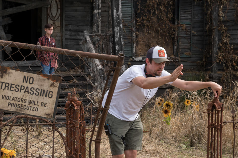 ‘Mama’ director Andy Muschietti on set outside the house on Neibolt street where the Losers’ Club track down Pennywise. The the background stands Jaeden Lieberher, who plays Stuttering Bill. (Warner Bros.)