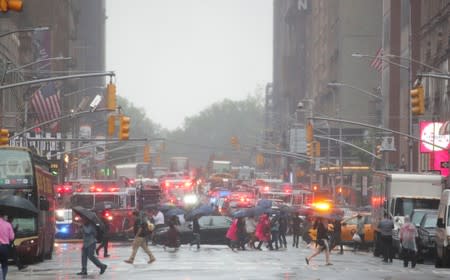 Emergency vehicles fill the street at the scene after a helicopter crashed atop a building in New York