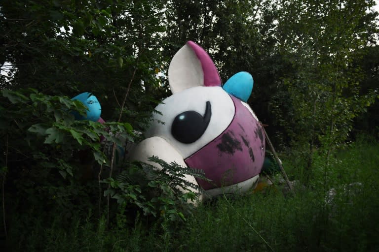 Paralympic mascot Fu Niu Lele lies abandoned outside an unfinished mall in Beijing