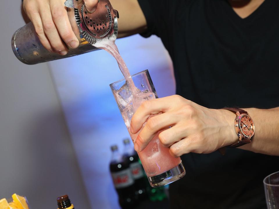 bartender pouring drink cocktail