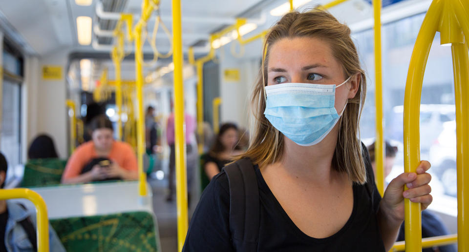 Woman wears a mask on a Melbourne tram. Source: Getty