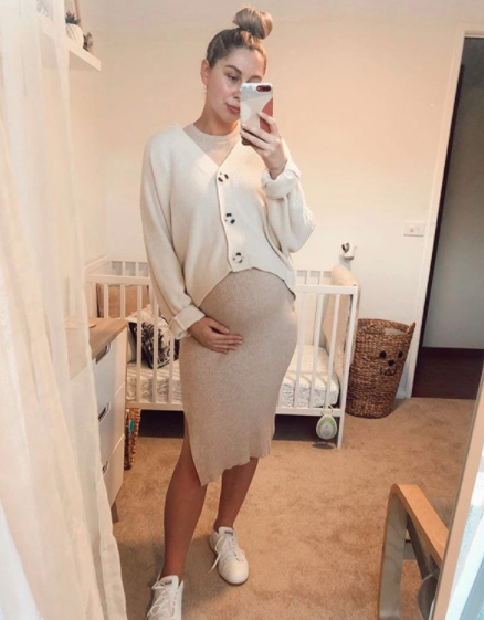 Pregnant woman in a Kmart cardigan