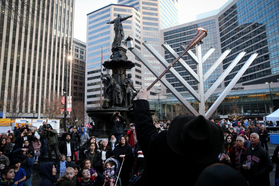 Rabbi Sholom Kalmanson lit an 18-foot Hanukkah menorah at Fountain Square in 2019.