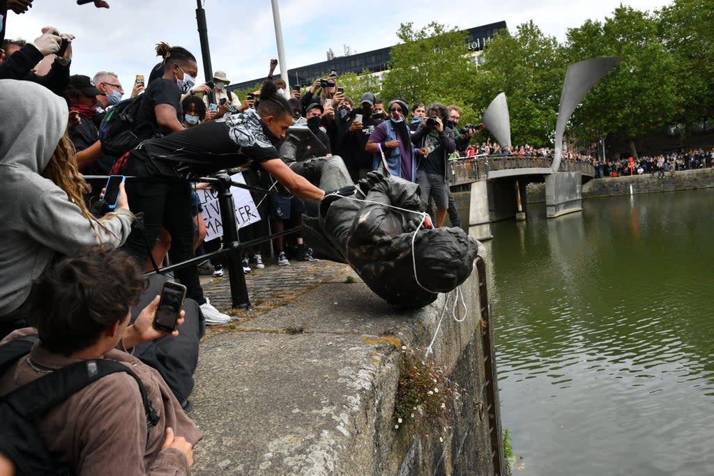 Protesters throw a statue of Edward Colston into Bristol harbour during a Black Lives Matter protest (Ben Birchall/PA) (PA Archive)
