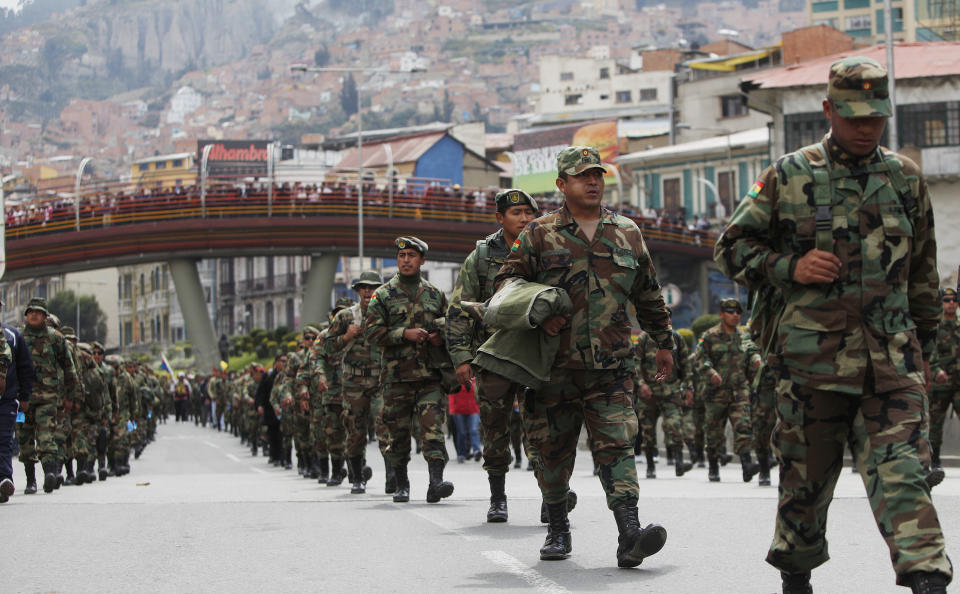 Air Force and Army soldiers march on the third day of protests in La Paz, Bolivia, Thursday, April 24, 2014. Enlisted soldiers are protesting the military high command's dismissal of four of its leaders who defended their call for changes so that non-commissioned officers may study to become career officers. (AP Photo/Juan Karita)