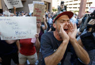 <p>Protesters outside the Phoenix Convention Center hold up anti-U.S. President Donald Trump signs and shout back at Trump supporters waiting to enter a rally held by Trump on August 22, 2017 in Phoenix, Arizona. (Ralph Freso/Getty Images) </p>