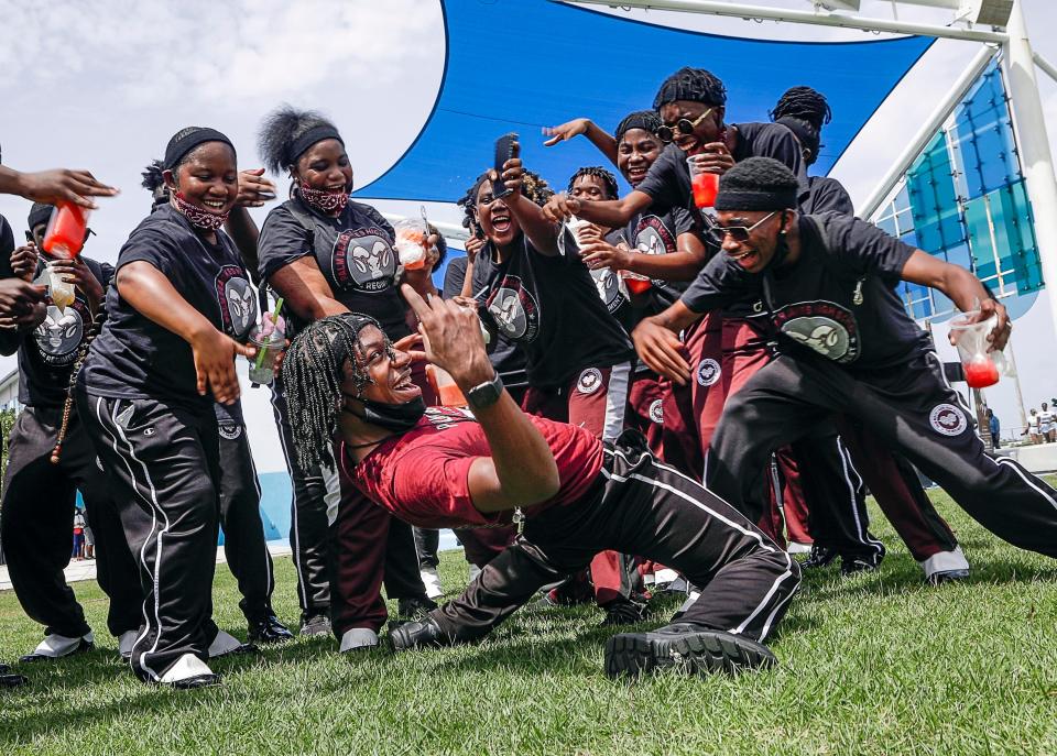 Palm Beach Lakes high school drum major Maxwell Rolle leans way back while dancing with his bandmates at a Juneteenth festival held at the Rivera Beach Marina Village, June 19, 2021. The event was free to the public and featured food, music from X102.3, local vendors, and fun and games for kids.