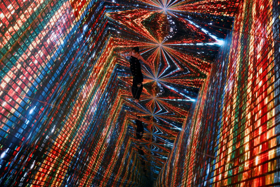 A visitor is pictured in front of an immersive art installation titled 