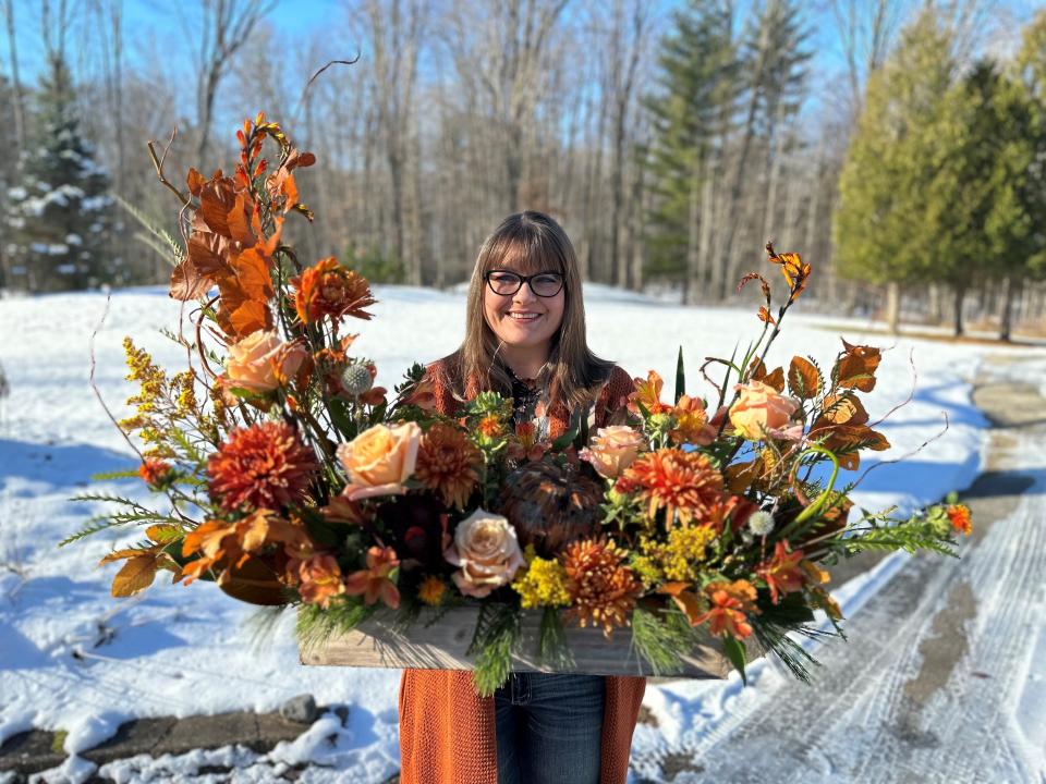 Stephanie Schoel, owner of Secret Garden Floral Design in Oconto, shows off the first arrangement she made out of her own shop, a Thanksgiving statement piece for a family gathering.