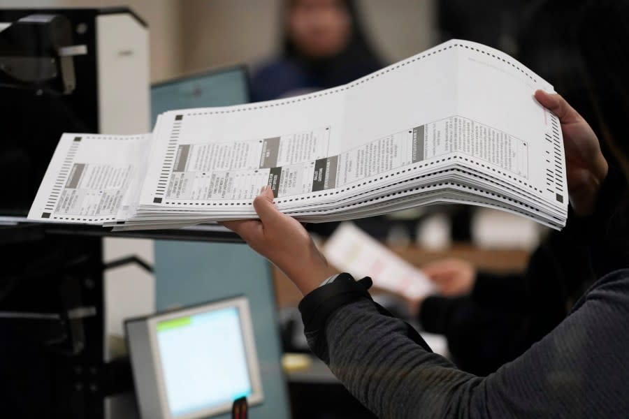 <em>An election worker processes ballots at the Clark County Election Department, Friday, Nov. 11, 2022, in Las Vegas. (AP Photo/John Locher)</em>