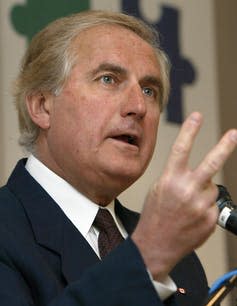 Roy Romanow gestures while speaking.