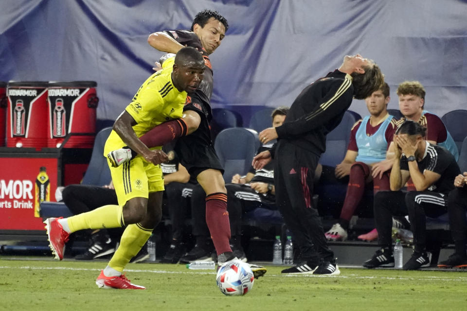 Atlanta United coach Gabriel Heinze, right, reacts to a play as Nashville SC defender Nick Hinds, left, and Atlanta defender George Bello (21) vie for the ball during the first half of an MLS soccer match Thursday, July 8, 2021, in Nashville, Tenn. (AP Photo/Mark Humphrey)